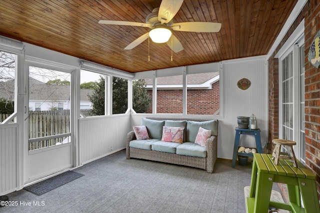 sunroom / solarium with ceiling fan and wooden ceiling