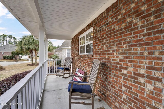 front facade featuring covered porch, a front lawn, and a garage