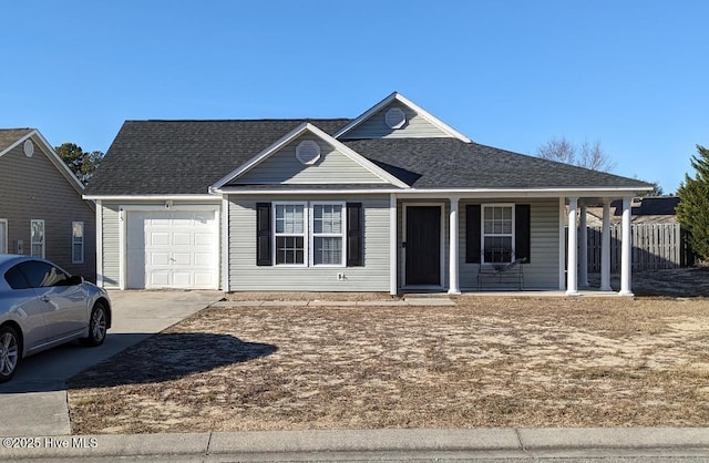 view of front of property featuring covered porch and a garage