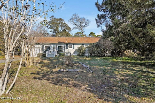 rear view of property with a lawn