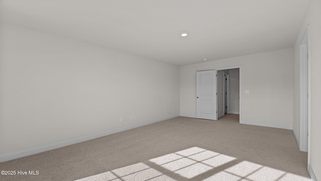 unfurnished room featuring light carpet