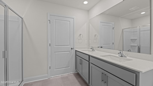 bathroom with vanity and a shower with door