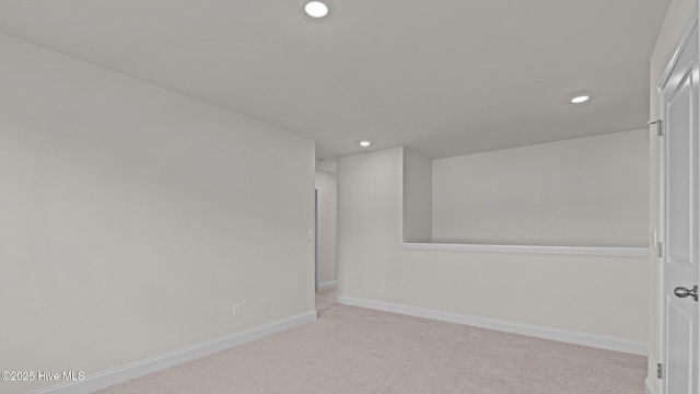 unfurnished room with light carpet