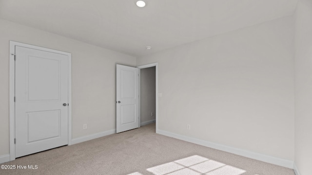 unfurnished bedroom with light carpet