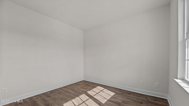 spare room with dark hardwood / wood-style flooring