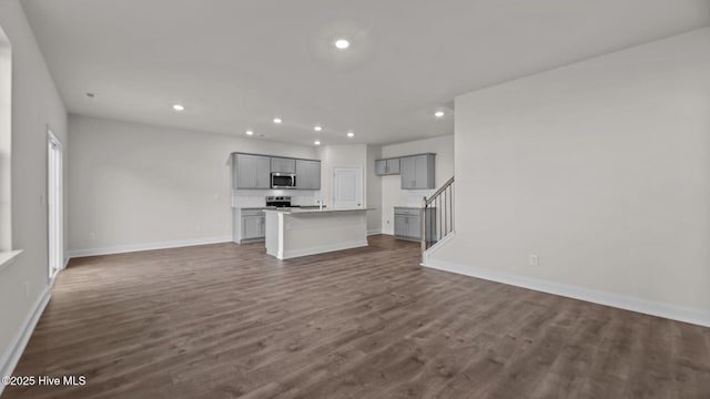 unfurnished living room with dark hardwood / wood-style flooring