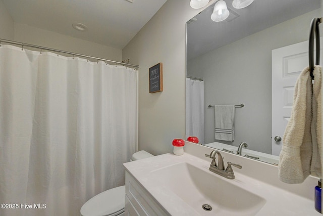 bathroom featuring toilet and vanity