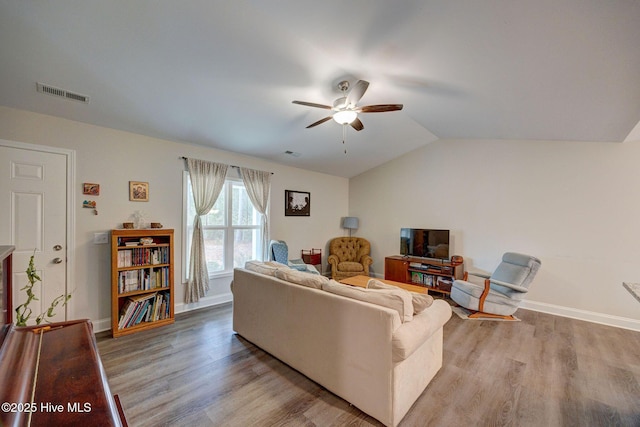 living room with ceiling fan, vaulted ceiling, and light hardwood / wood-style flooring