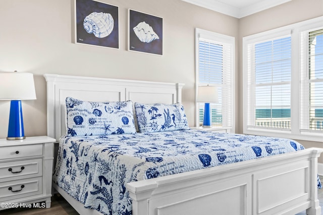 bedroom with dark wood-type flooring and ornamental molding