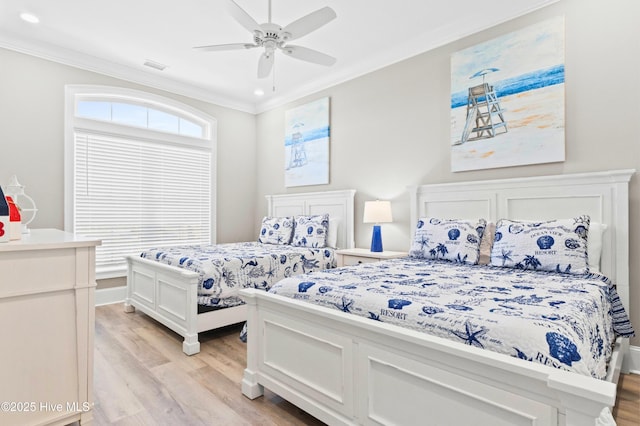 bedroom with light wood-type flooring, ceiling fan, and ornamental molding