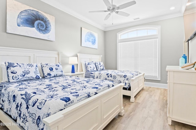 bedroom featuring ceiling fan, light hardwood / wood-style flooring, and crown molding