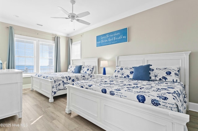 bedroom with ceiling fan, crown molding, and light hardwood / wood-style floors