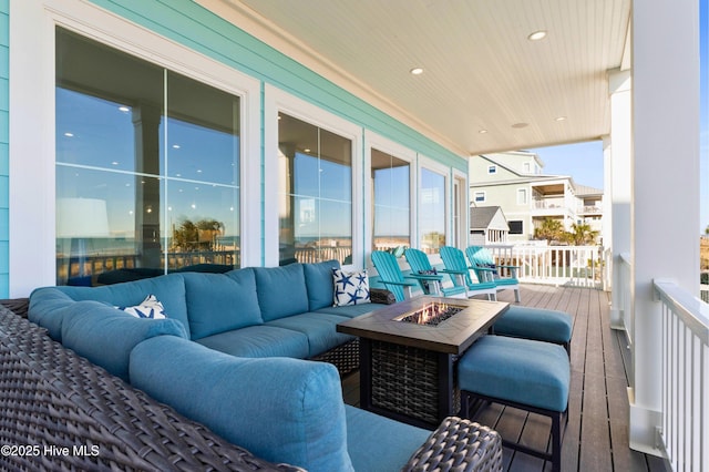 balcony with an outdoor living space with a fire pit