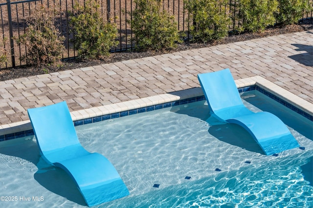 view of swimming pool with a jacuzzi