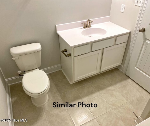 bathroom featuring tile patterned flooring, vanity, and toilet