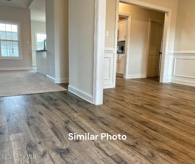 unfurnished room with dark wood-type flooring