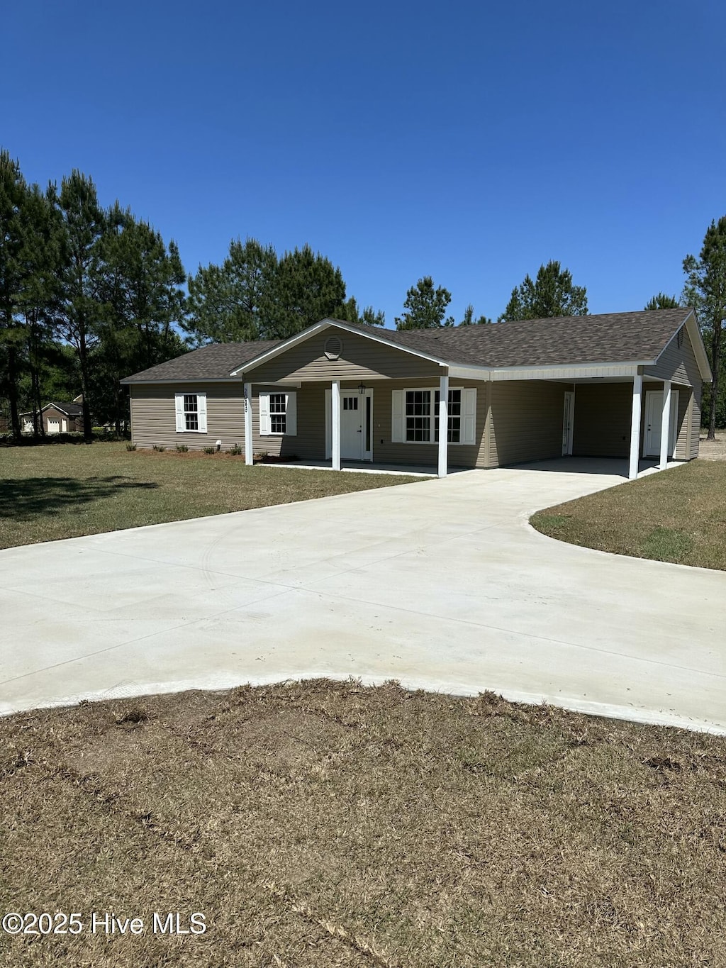 ranch-style house with a carport and a front lawn