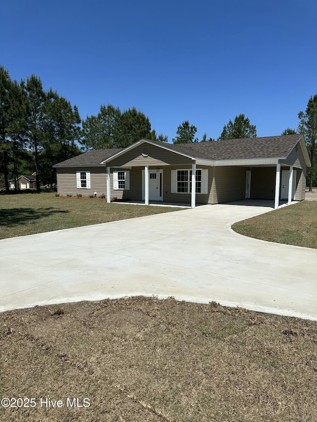 ranch-style house with a carport and a front lawn