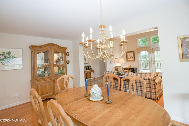 dining area featuring a chandelier and light hardwood / wood-style floors