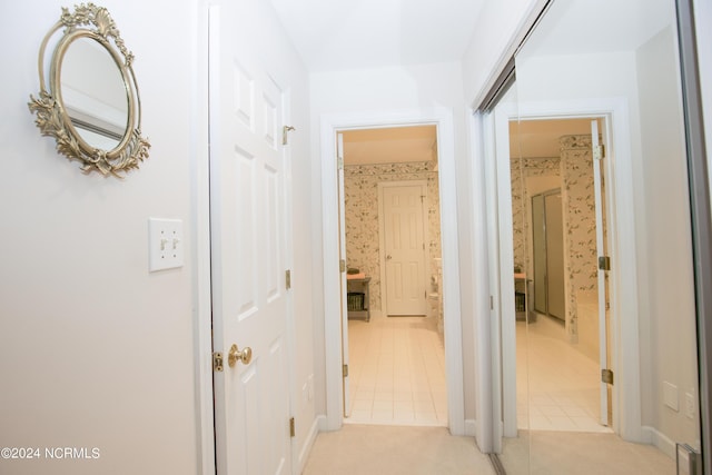 hall featuring light tile patterned floors