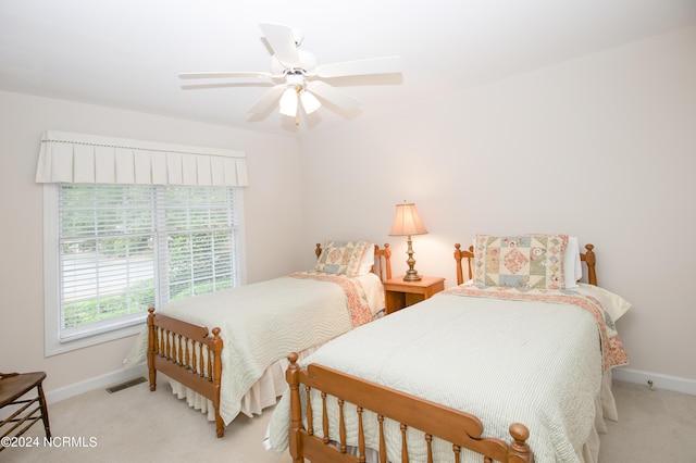 bedroom with ceiling fan and light carpet