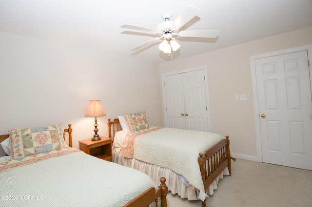 bedroom featuring ceiling fan, light colored carpet, and a closet