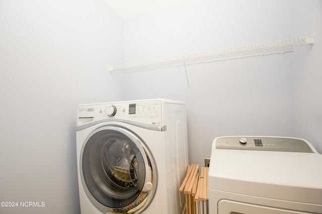 laundry area featuring washing machine and clothes dryer