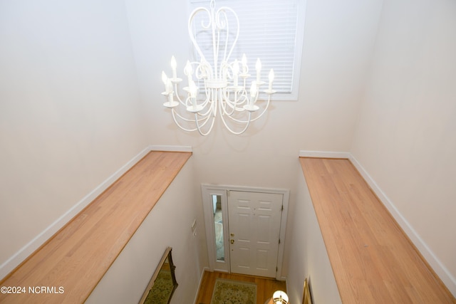 stairs featuring a chandelier