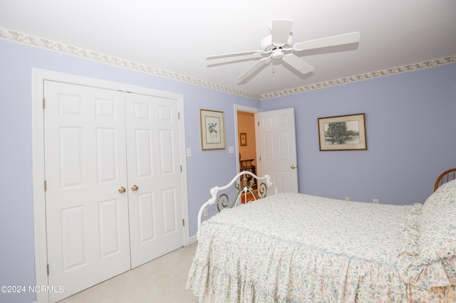 bedroom featuring ceiling fan, a closet, and light carpet