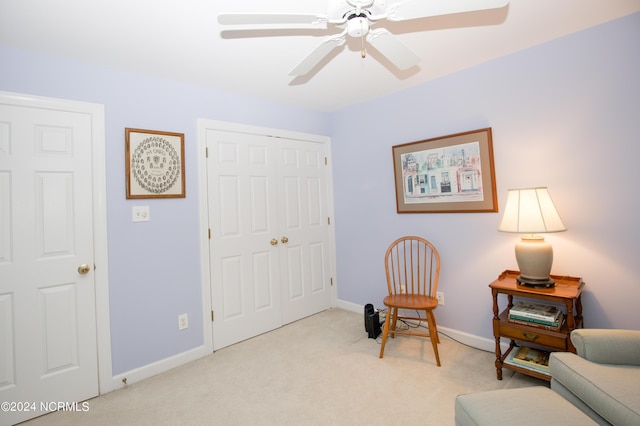 sitting room featuring ceiling fan and light carpet