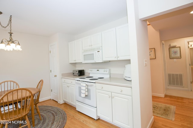 kitchen featuring white appliances, light hardwood / wood-style flooring, hanging light fixtures, an inviting chandelier, and white cabinetry