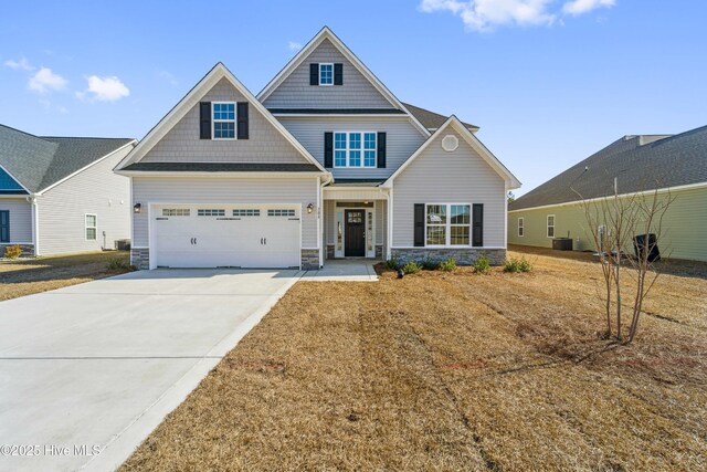 craftsman house featuring a garage and a front yard