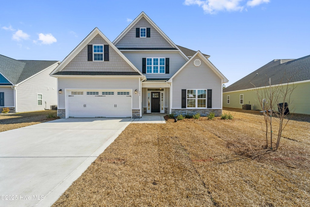 craftsman-style house with a garage and central AC