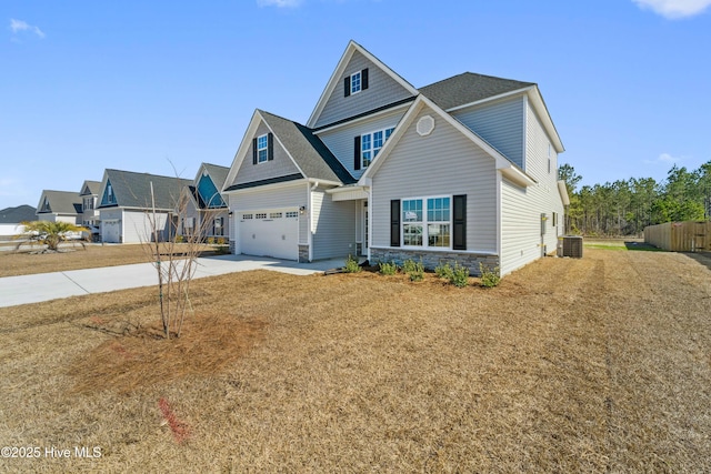 view of front of house featuring central AC unit, a garage, and a front yard