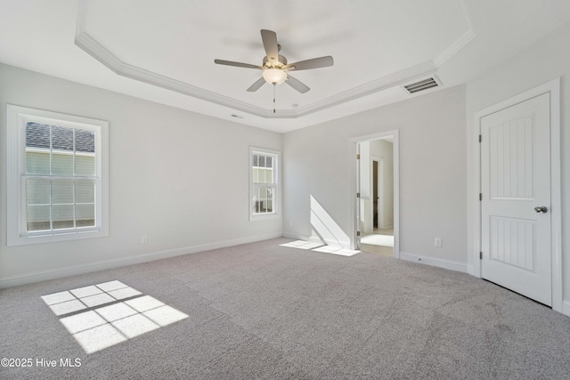 unfurnished bedroom featuring crown molding, ceiling fan, a tray ceiling, and light carpet