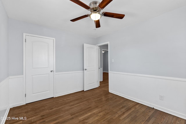 unfurnished bedroom featuring ceiling fan, dark wood-type flooring, and a closet