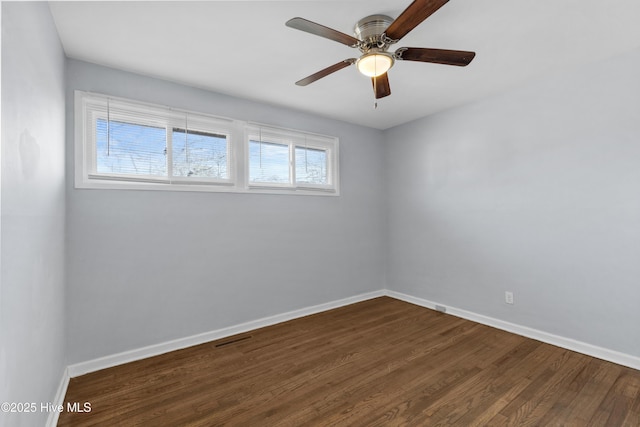 spare room featuring ceiling fan and dark hardwood / wood-style floors