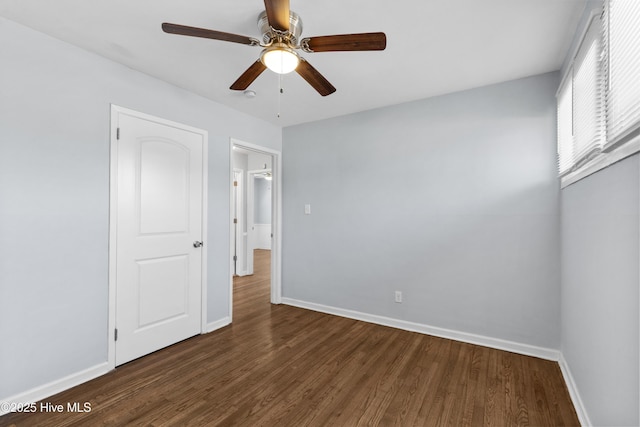 unfurnished bedroom with ceiling fan and dark hardwood / wood-style flooring