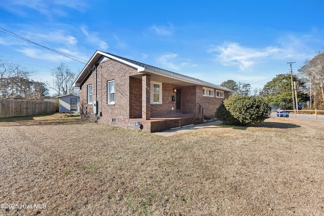 view of side of home with a lawn