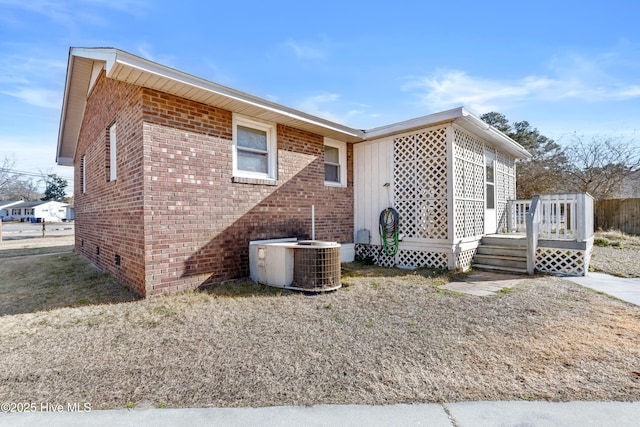 view of home's exterior with central AC unit and a wooden deck