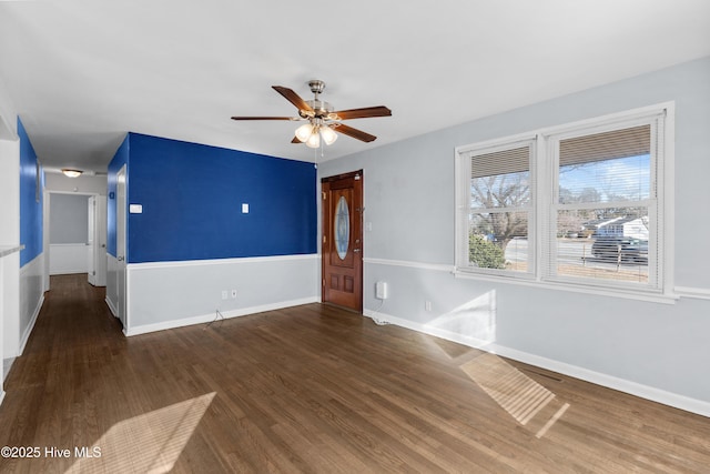 spare room with ceiling fan and dark wood-type flooring