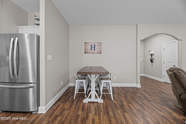 dining space with dark hardwood / wood-style floors