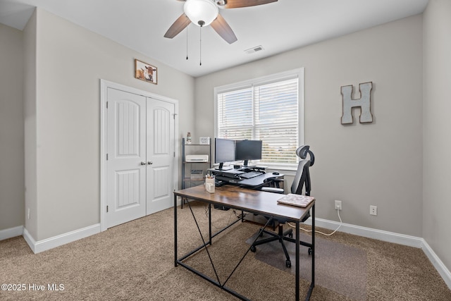 carpeted home office with ceiling fan