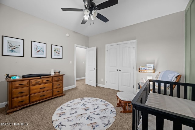 bedroom featuring light carpet, a closet, and ceiling fan