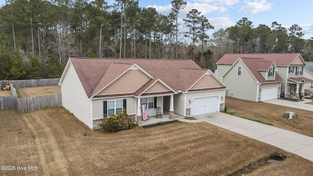 view of front of property featuring a front yard, a porch, and a garage