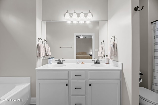 bathroom with ceiling fan, toilet, a tub, and vanity