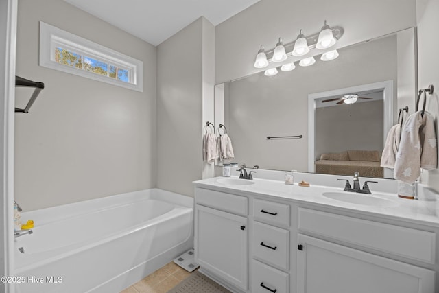 bathroom with a washtub, vanity, tile patterned floors, and ceiling fan