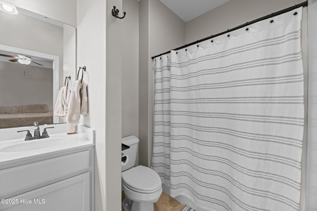 bathroom with vanity, toilet, and ceiling fan