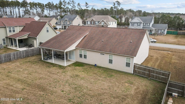 rear view of property featuring a yard and a patio