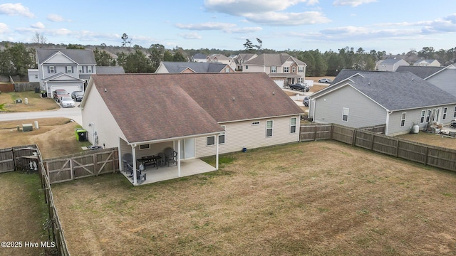 back of property with a lawn and a patio area